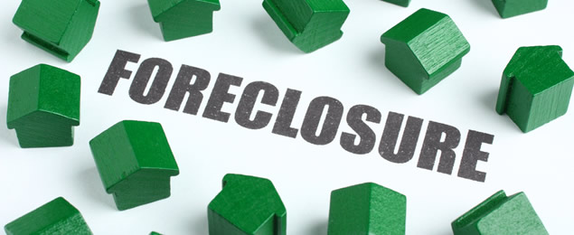 Small Green Houses Around a Foreclosure Sign