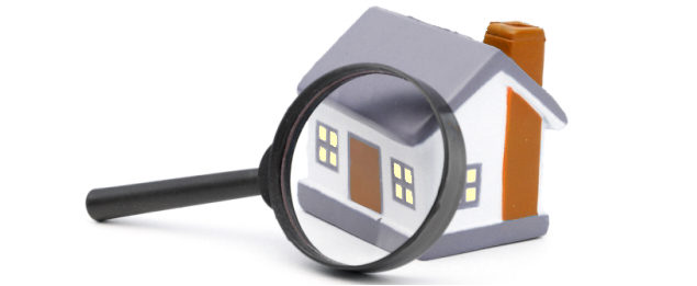 Magnifying Glass Examining Model Home